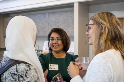 Tina Savla and Amy Azano talk with event attendee.