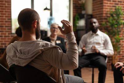 People sitting in a circle talking.