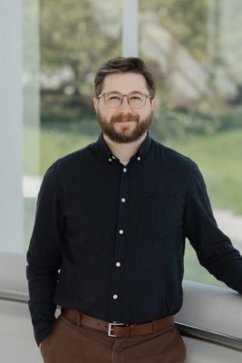 Photo of Dustin Covey, ISCE's IT Support Person, on ISCE front porch. 