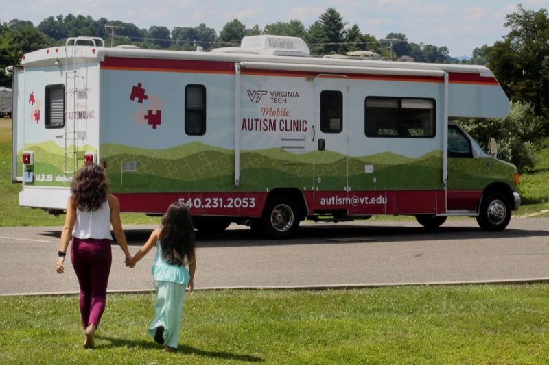 Women and child walking to Virginia Tech Mobile Autism Clinic